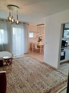 a living room with a table and a dining room at Moderne 3Zimmer Wohnung, in Königsbrunn bei Augsburg in Königsbrunn