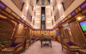 a room with chairs and a table in a building at Levant Hotel فندق قصر المشرق in Najran