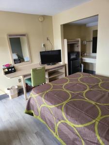 a hotel room with a bed and a desk at Budget Host Inn Bristol in Bristol