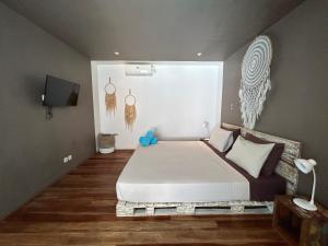 a bedroom with a large white bed in a room at Meno Suites in Gili Meno