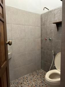 a bathroom with a toilet and a shower at Dewa Daru Resort in Karimunjawa