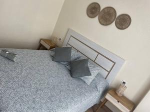 a bedroom with a bed and two hats on the wall at Espectacular piso en la playa in Gijón