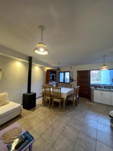 a living room with a dining table and a kitchen at Las Lavandas Purmamarca in Purmamarca