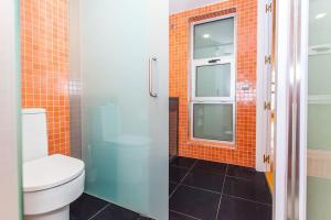 een badkamer met een toilet en een glazen douche bij Atocha: Precioso con Parking y Piscina at Lavapies in Madrid
