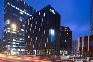 a tall building with a clock on the side of it at Motel One Berlin-Spittelmarkt in Berlin