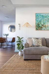a living room with a couch and a table at By the Bay Batehaven - King, Queen, 2 x Singles in Batehaven
