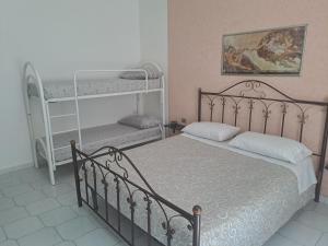 a bedroom with a bed and two bunk beds at B&B SAN MARCO in San Marco Evangelista