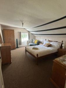 a bedroom with a bed and a couch in it at Number 2 at The Red Lion in Huntley