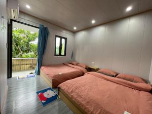 1 dormitorio con 2 camas en una habitación con ventana en Homestay Hoa ban en Mộc Châu