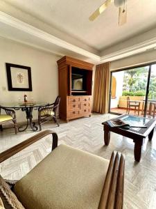 a living room with a couch and a table at Departamento Frente a la Playa, Velas Vallarta in Puerto Vallarta