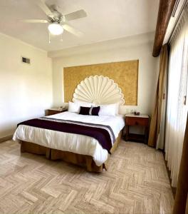 a bedroom with a large bed and a ceiling at Departamento Frente a la Playa, Velas Vallarta in Puerto Vallarta
