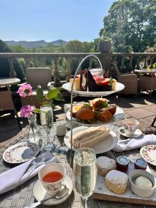 een tafel met borden eten en drinken erop bij Peterstone Court Country House Restaurant & Spa in Brecon