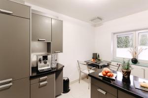 a kitchen with a counter with a sink and a microwave at Neue Technologie Systemlösungen GmbH in Osterode +12 photos