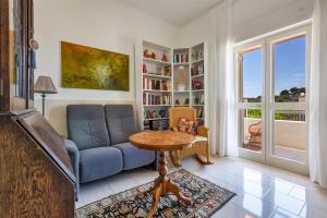 Una sala de estar con un sofá azul y una mesa. en Casa di Margherita by BarbarHouse, en San Pietro in Bevagna