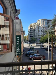 a view of a street with cars parked in a parking lot at Palm Hotel in Batumi