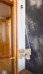 a light hanging from a wall in a room at AMRAI Karamella in Ventspils +22 photos