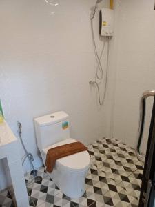 a bathroom with a toilet and a shower at Kipbox Hotel Trang in Trang