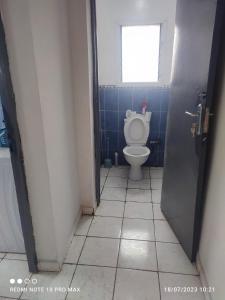 a bathroom with a toilet and a window at Villa Saphira in Antananarivo