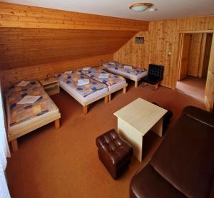 an overhead view of a room with beds and a table at Hostinec u Řeky in Ostravice