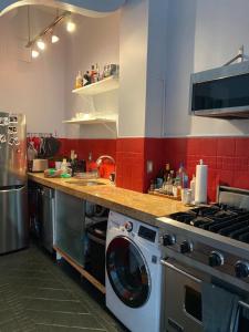 a kitchen with a stove and a washing machine at Charming Studio West Village in New York