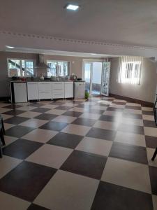 an empty room with a checkered floor in a house at Zhanas home anaklia in Anaklia
