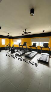 a gym with chairs and a sign on the floor at Duan Homestay @ Cybersouth (Muslim shj) in Kampung Dengkil