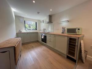 a large kitchen with a counter and a microwave at Flat in Gourock - The Wedge in Gourock