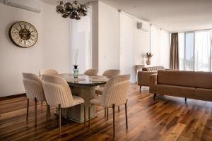 a dining room with a table and chairs and a couch at Cape Montenegro Villas in Krimovice