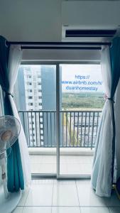 a room with a view of a balcony with a window at Duan Homestay at Cybersouth in Kampung Dengkil