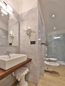 a bathroom with a sink and a toilet at Hotel San Donato - Bologna centro in Bologna