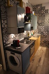 a kitchen with a washing machine and a washer at Orticello Appartment in San Sperate
