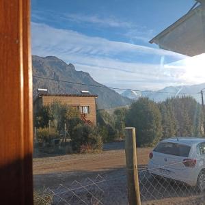 un coche aparcado fuera de una casa con una valla en Tiny house Bariloche en San Carlos de Bariloche