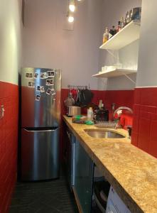 a kitchen with a stainless steel refrigerator and a sink at Charming Studio West Village in New York