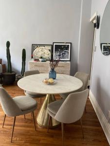 a dining room with a white table and chairs at Charming Studio West Village in New York