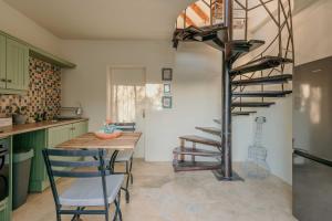 a kitchen with a wooden table and a spiral staircase at Silky Oaks Couples Retreat in Riebeek-Kasteel
