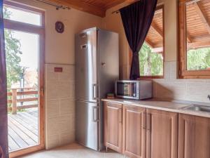 a kitchen with a stainless steel refrigerator and a window at Orion in Borzont