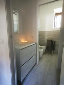 a bathroom with a white sink and a toilet at Da Roxy in Casale Litta