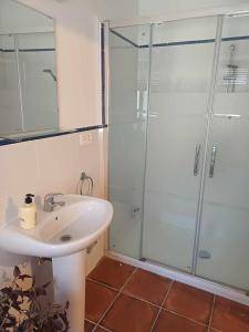 a bathroom with a white sink and a shower at Ascent At Alora in Málaga