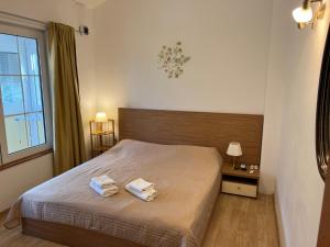 a bedroom with a bed with two towels on it at Zubci mountain apartment in Bar