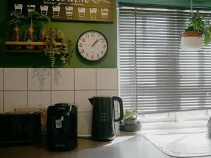 a kitchen counter with a clock on the wall at Westgate Garden riverside in Canterbury