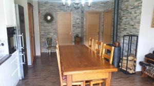 a dining room with a wooden table and chairs at CHEZ ANTOINE in Saint-Pierre-dels-Forcats +2 photos