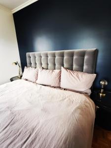 1 dormitorio con 1 cama blanca grande y pared negra en Le Versailles suite en Versalles