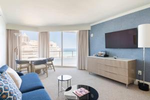 a living room with a blue couch and a large window at Fontainebleau #1 Luxury Relax in Miami Beach