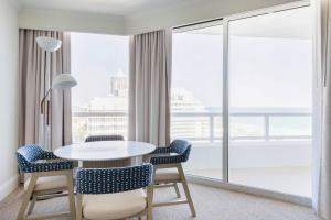 a room with a table and chairs and a large window at Fontainebleau #1 Luxury Relax in Miami Beach