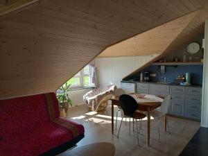 a living room with a couch and a table in a kitchen at Frostastaðir Guesthouse in Varmahlid