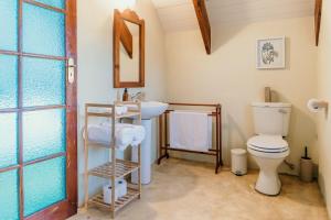 a bathroom with a toilet and a sink at Silky Oaks Couples Retreat in Riebeek-Kasteel +26 photos