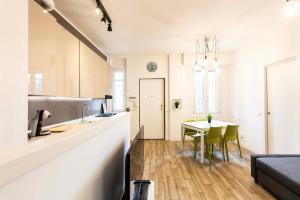 a kitchen and living room with a table and a counter at Bellarmino 21 in Milan