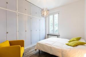 a bedroom with a bed and a chandelier at Bellarmino 21 in Milan