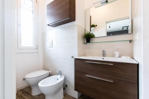 a bathroom with a toilet and a sink and a mirror at Bellarmino 21 in Milan +50 photos