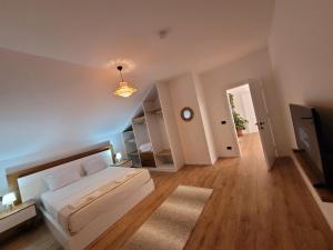 a large bedroom with a bed and a light at Bujtina Bezhani Gjinar in Elbasan